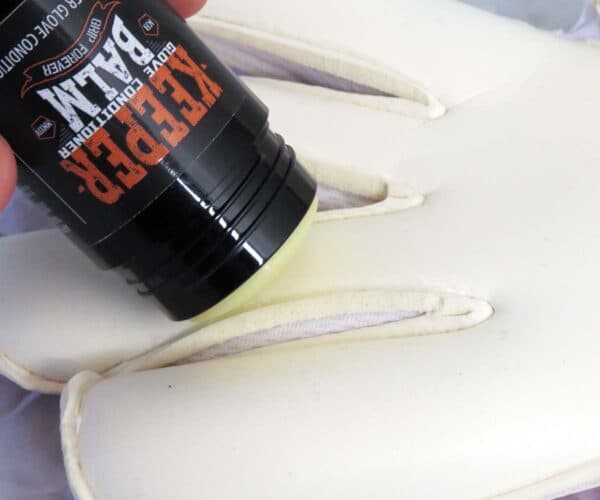 Applying KEEPER BALM to goalkeeper gloves