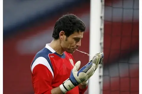 Goalkeeper spitting on gloves